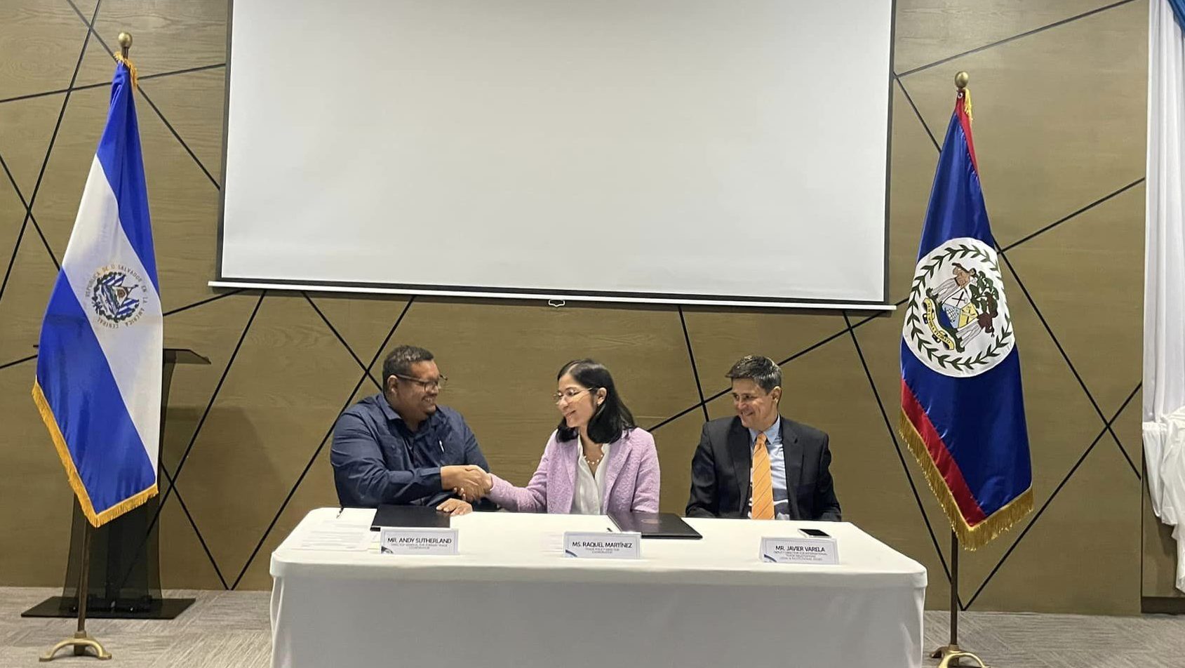 The Directorate General for Foreign Trade of Belize and The Director General for El Salvador Shake hands after signing on the agreed chapters on the PSA.